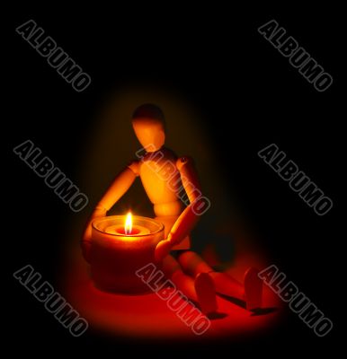 wood mannequin and candle