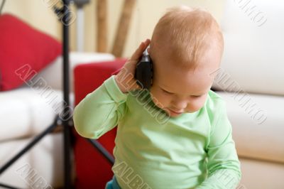 Little boy call by wireless phone at home