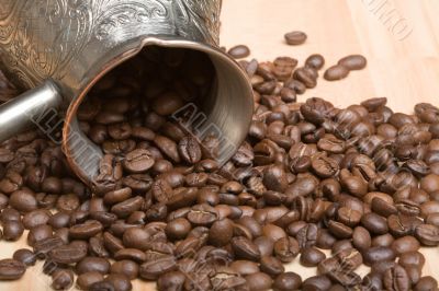 Cezve and roasted coffee beans on the table