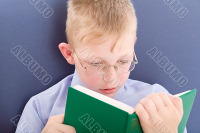 Boy reading interesting book