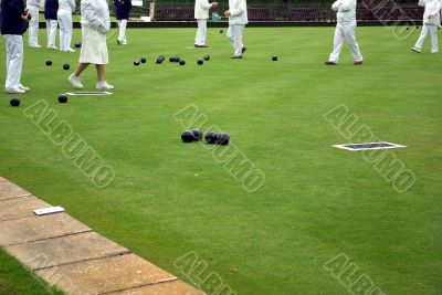 Many people playing lawn bowling