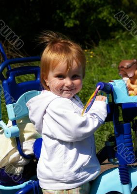 Girl and her tricycle Girl and her tricycle