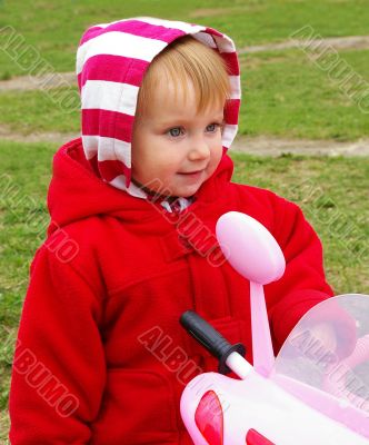 Little nice girl and her tricycle