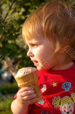 Girl eats ice-cream in the summer