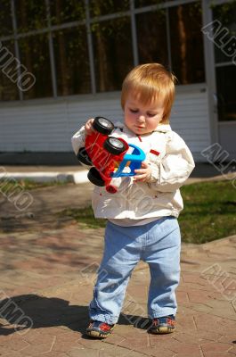 Little girl plays whith bright toy