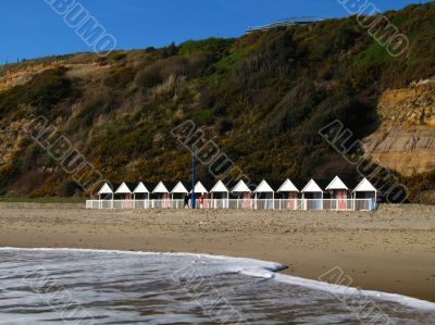 beach huts at cliff bottom