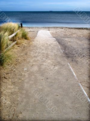 Pathway and fence leading to sea