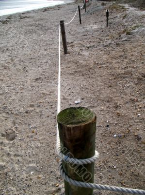 post and ropes on deserted beach