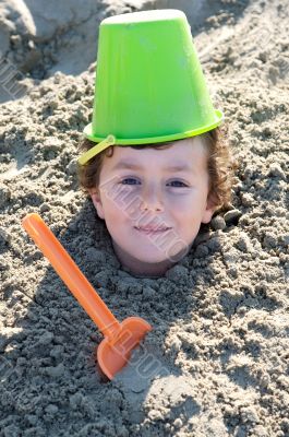Child buried in the sand Child buried in the sand