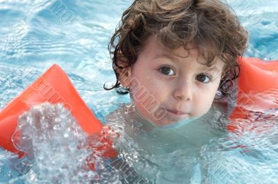 boy learning to swim