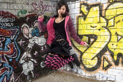 Teenager jumps before graffiti wall