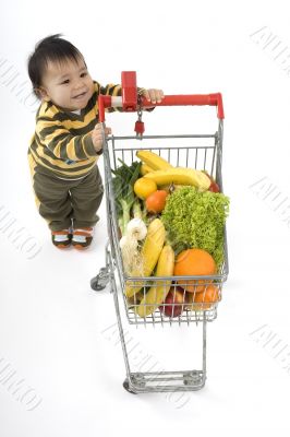 Baby pushes a shopping cart