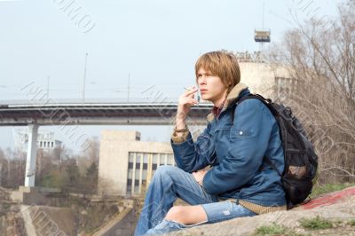 The sitting guy with a cigarette outdoor 1 The sitting guy with a cigarette outdoor 1
