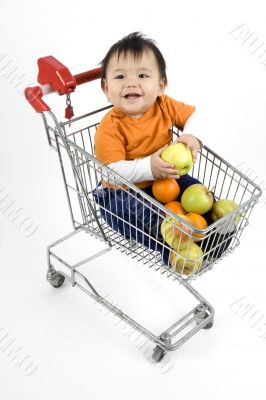 Baby pushes a shopping cart