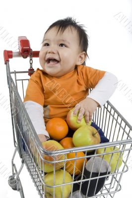 Baby pushes a shopping cart