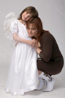 toddler in angel dress with her mother toddler in angel dress with her mother