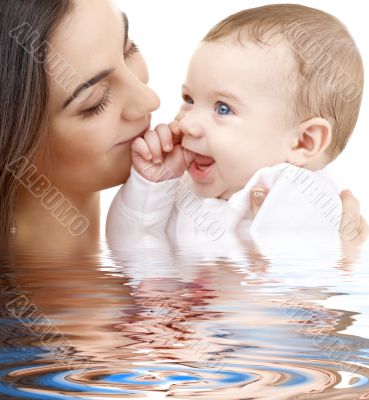 bathing baby in mother hands