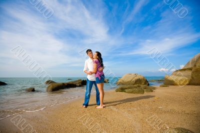 loving couple hugging each other on the summer beach