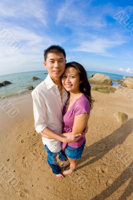 couple hugging on the beach during vacation