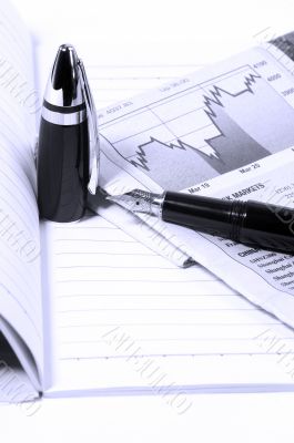 notebook  newspaper and pen