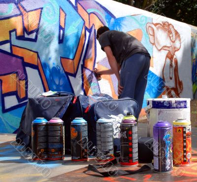 Graffiti artist at work with tools