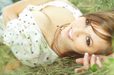 beautiful girl lying down of grass