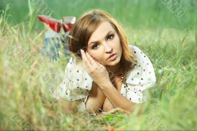 beautiful girl lying down of grass