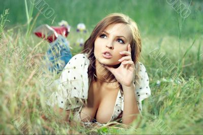 beautiful girl lying down of grass