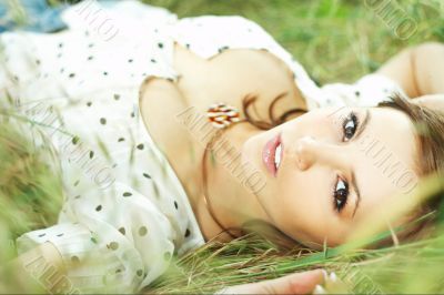 beautiful girl lying down of grass