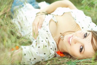 beautiful girl lying down of grass