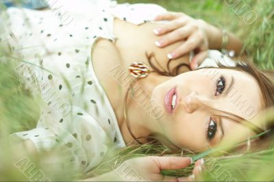 beautiful girl lying down of grass