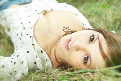 beautiful girl lying down of grass