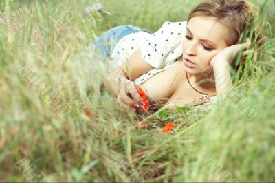 beautiful girl lying down of grass