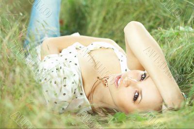 beautiful girl lying down of grass