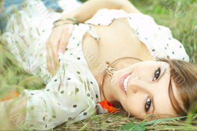 beautiful girl lying down of grass