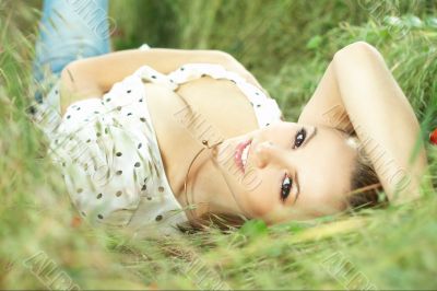 beautiful girl lying down of grass