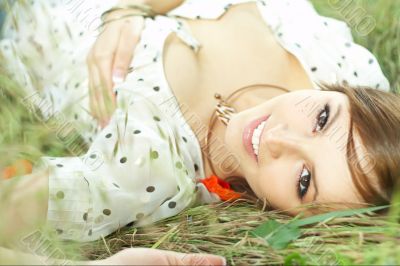 beautiful girl lying down of grass