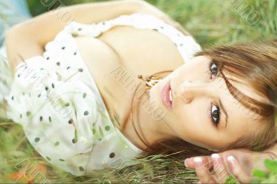 beautiful girl lying down of grass