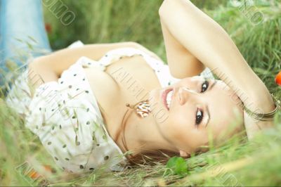 beautiful girl lying down of grass