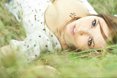 beautiful girl lying down of grass