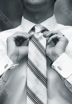 Man tying necktie