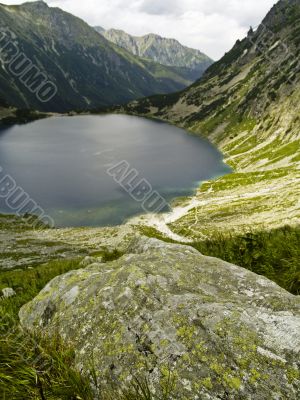 Big stone in background lake