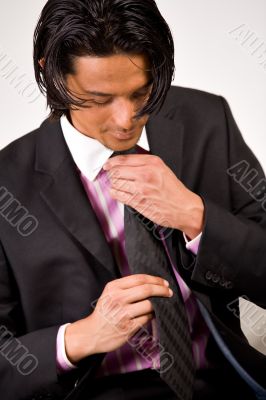 Young man bounding his necktie
