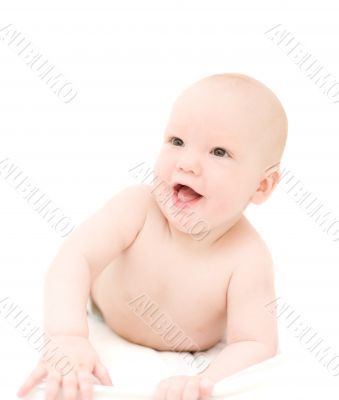 Funny little baby lying on white bed