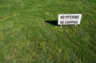 No Pitching or Chipping Sign on Lush Green Grass No Pitching or Chipping Sign on Lush Green Grass