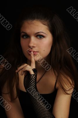 Young girl with a finger near the lips
