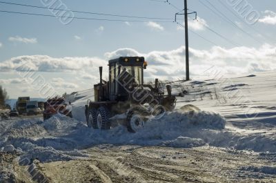 Grader removing snow