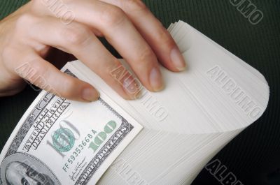 Woman fanning Large Stack of One Hundred Dollar Dollar Bills