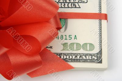 One Hundred Dollar Bills Wrapped in Red Ribbon.