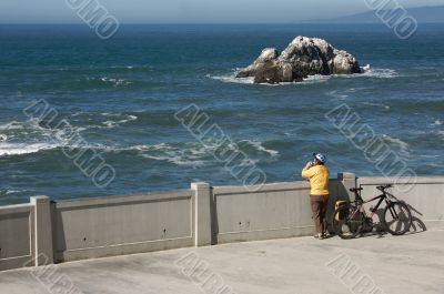Bicyclist Rests Near Ocean